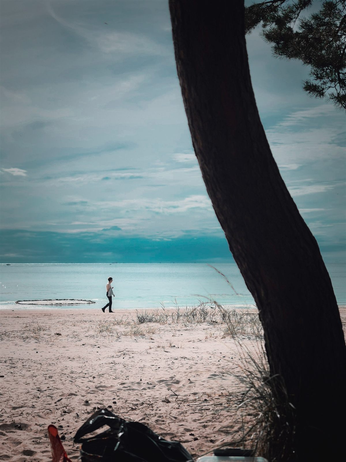Boy on a beach under an azure sky